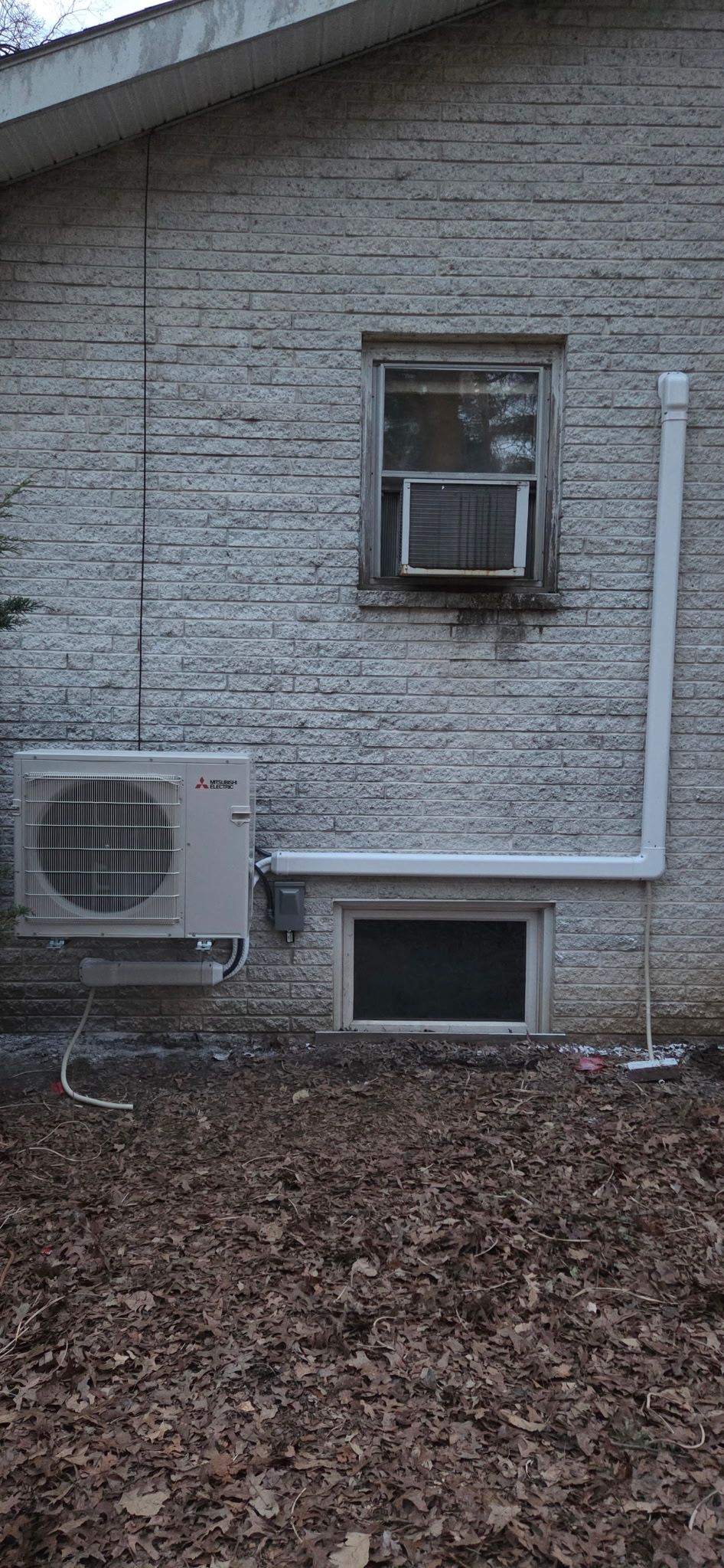 Mitsubishi Electric ductless mini-split heat pump installed on a brick home by Keystone Property Service